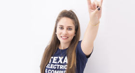 A woman wearing a t - shirt that says texas electrical and computer engineer.